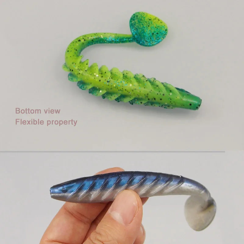 Soft plastic fishing lure with ribbed body and paddle tail, shown in green and blue colors.