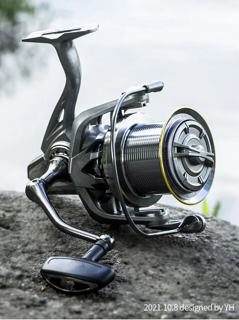 Close-up of a metallic spinning fishing reel on a rock, outdoor fishing gear.