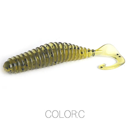 Ribbed soft plastic fishing lure with curled tail, olive green with black specks, isolated on white.