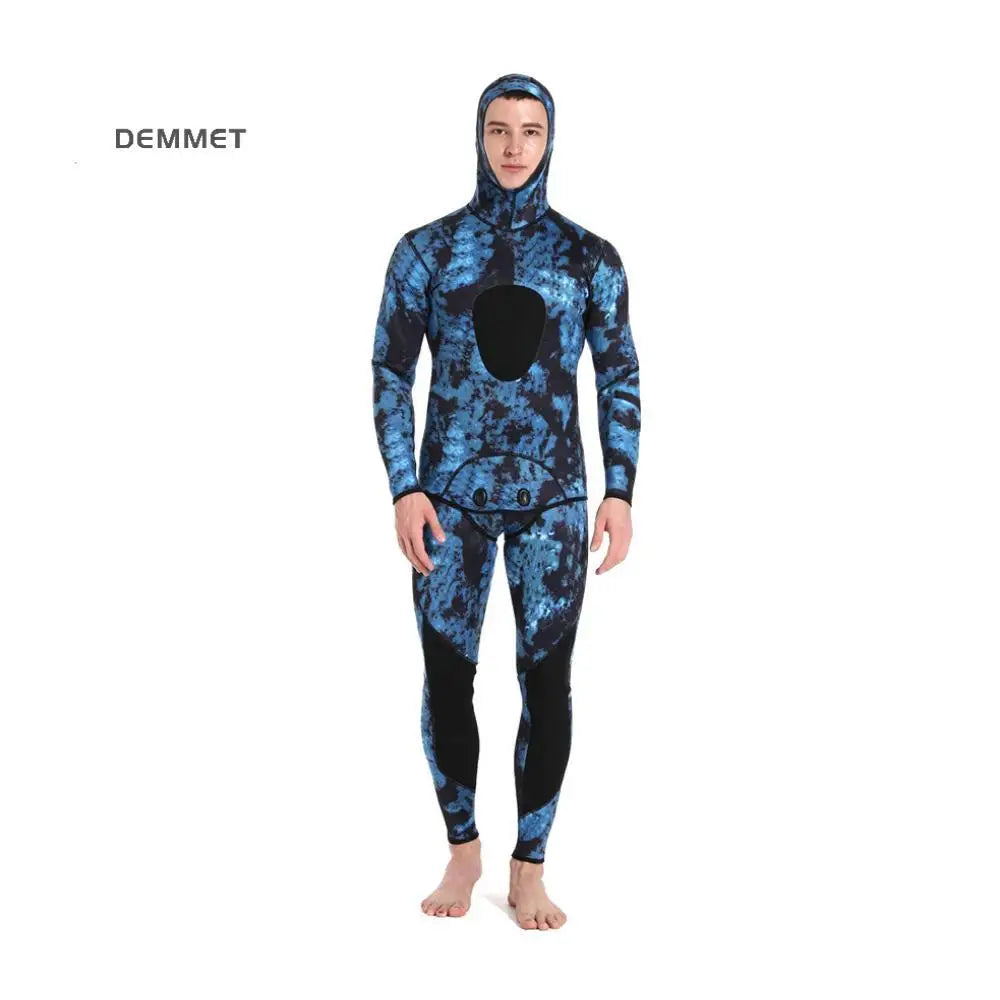 Person wearing a blue and black wetsuit with a hood on a white background, branded 'DEMMET'.