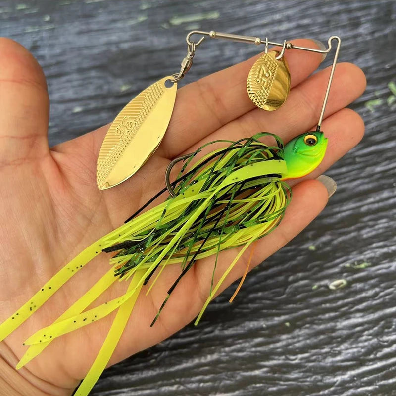 Hand holding a green and yellow spinnerbait fishing lure with gold blades