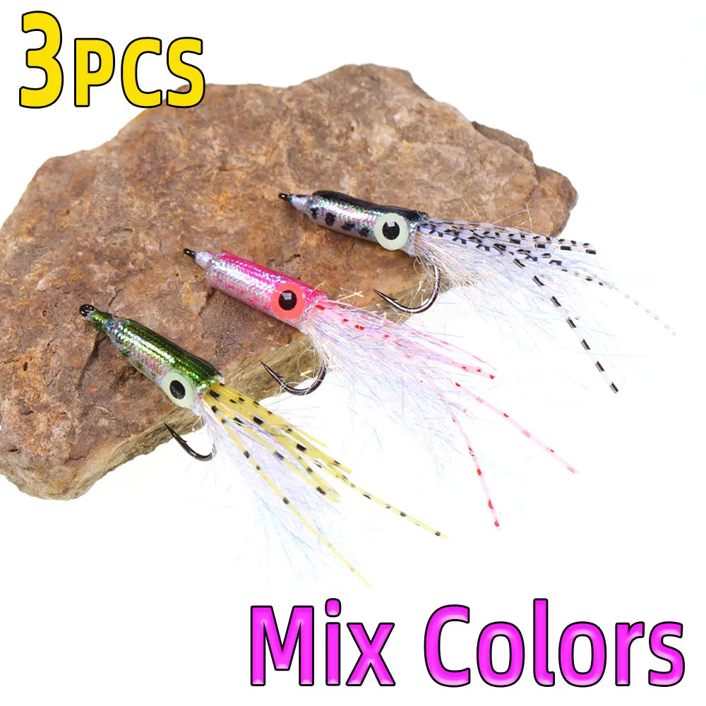 Set of 3 colorful fishing lures with hooks and tinsel tails on a rock, mix colors