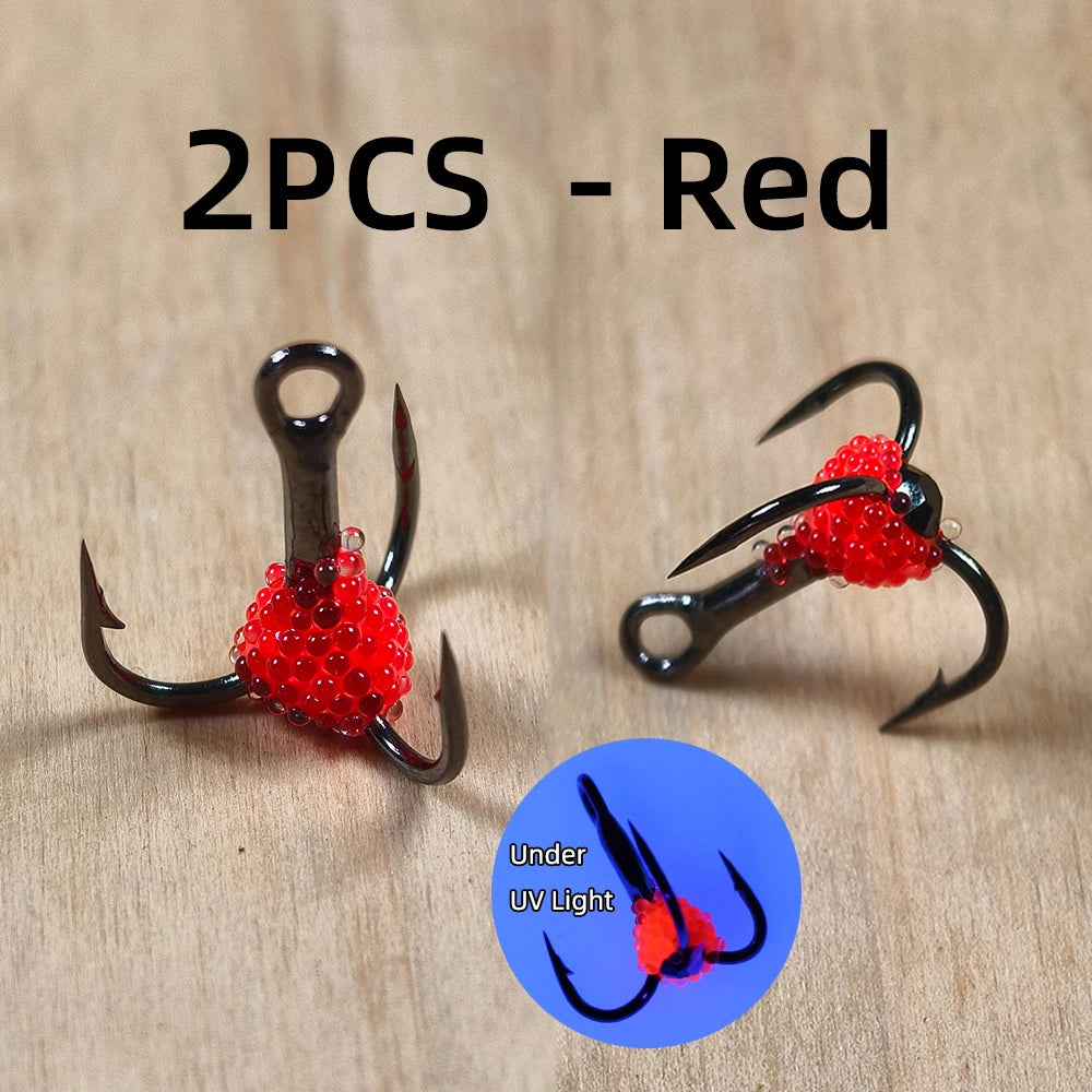 Red fishing treble hooks with bead accents, UV reactive, set of 2 on wood surface