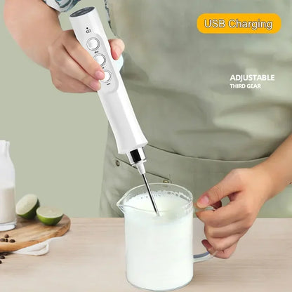 Handheld milk frother being used to froth milk in a glass with a USB charging feature highlighted.