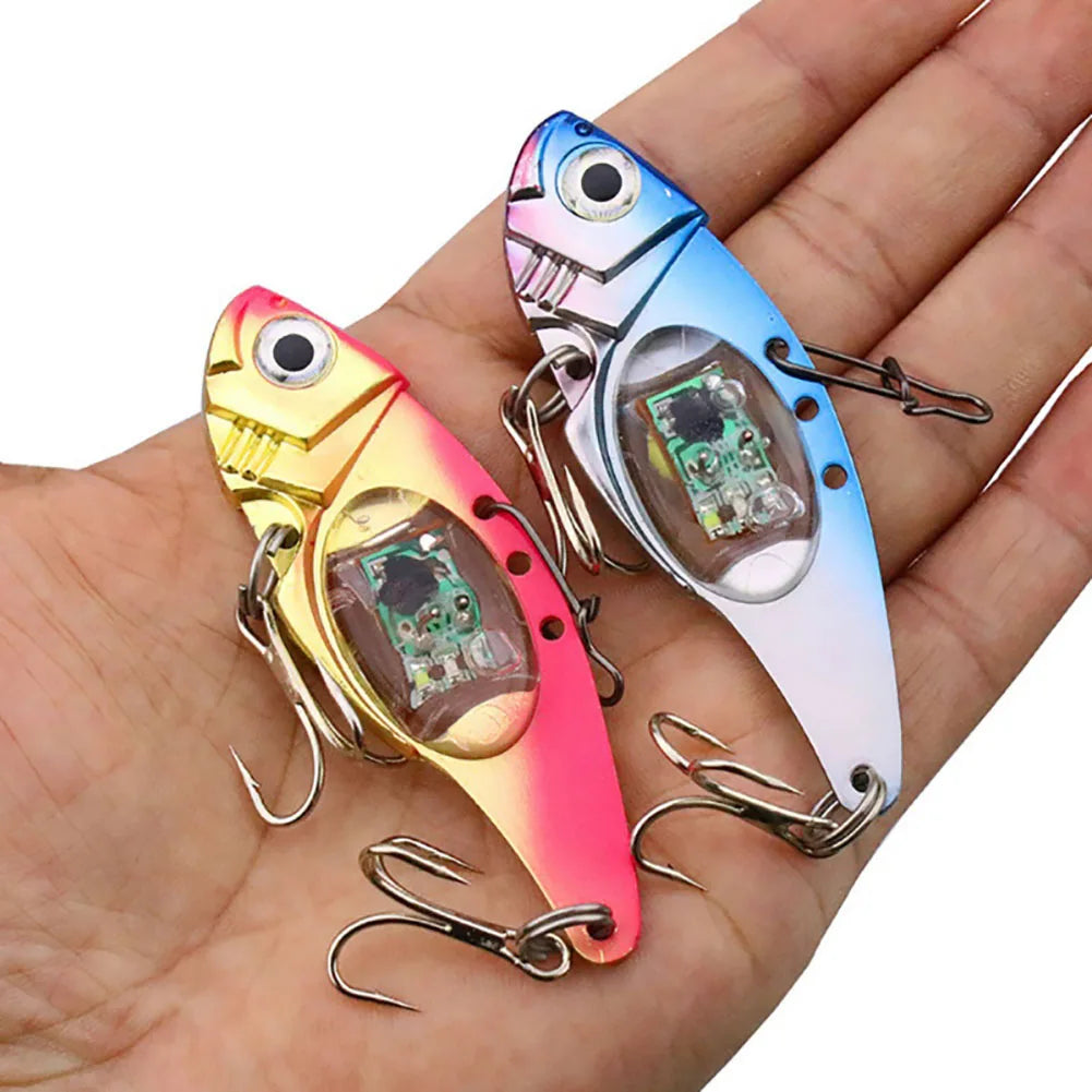 Two colorful electronic fishing lures held in a hand.