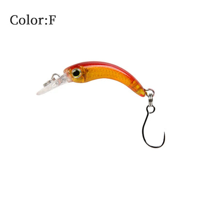 Red and orange fishing lure with a single hook and lifelike fish eye on white background.