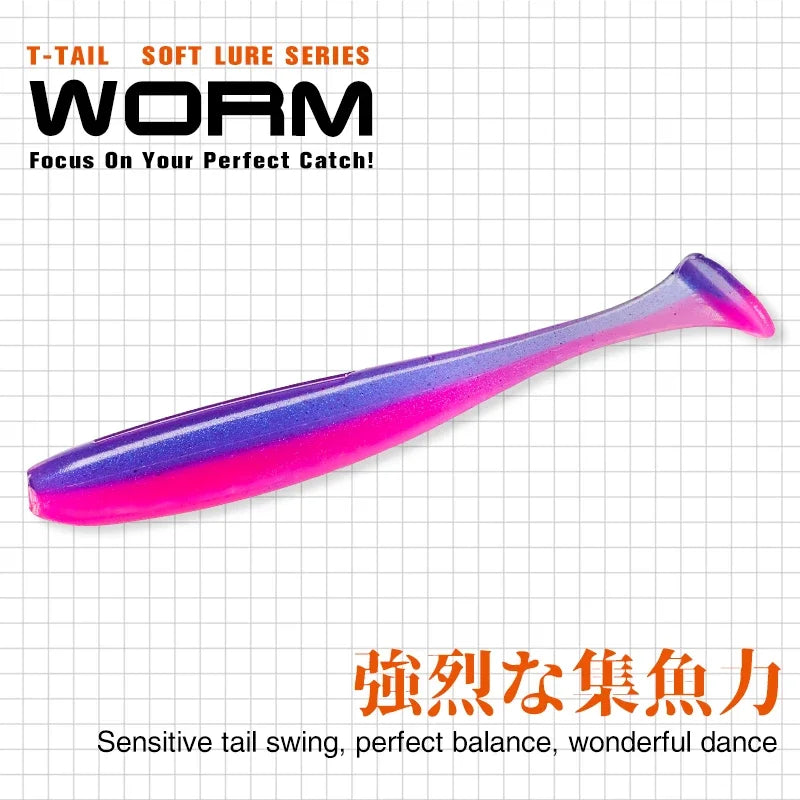 Pink and purple T-tail soft plastic fishing lure for outdoor fishing, grid background.