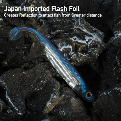 Blue and silver fishing lure with Japan imported flash foil on dark rocky surface