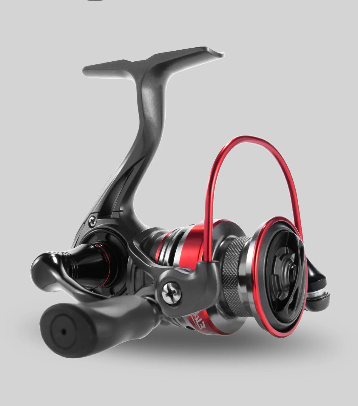 Close-up of a modern fishing reel with black and red metallic accents on a gray background