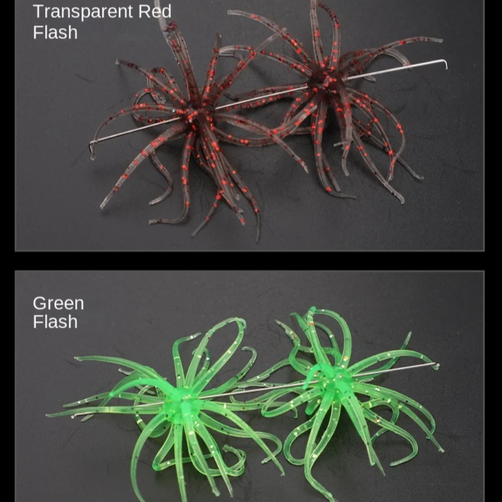 Transparent red and green flash soft bait fishing lures with multiple legs on a dark surface