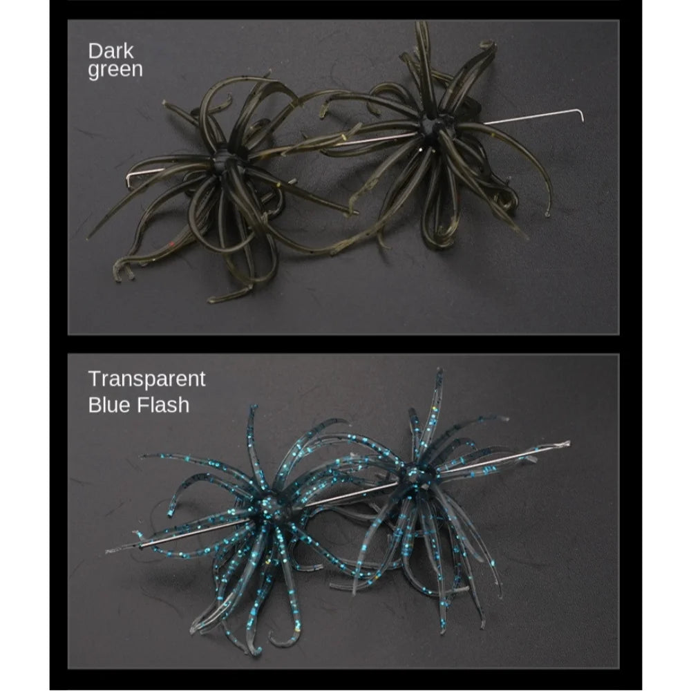 Two artificial soft bait fishing lures in dark green and transparent blue flash on black background.