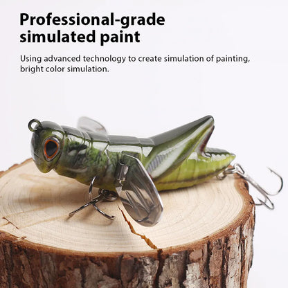 Realistic grasshopper fishing lure with simulated paint, displayed on a tree stump.