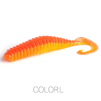 Orange and yellow ribbed soft plastic fishing lure with curly tail on white background