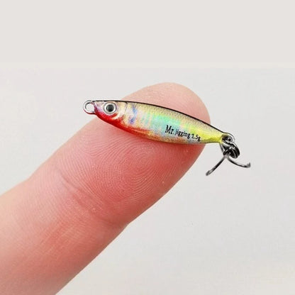 Miniature colorful fishing lure with hook displayed on fingertip, outdoor gear accessory