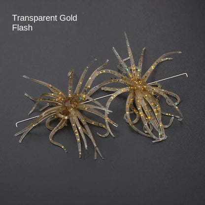 Transparent gold flash fishing lures with glitter detail on dark background