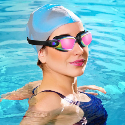 Anti-fog UV swim goggles with black strap and mirrored pink-lens lens set floating in blue pool water.