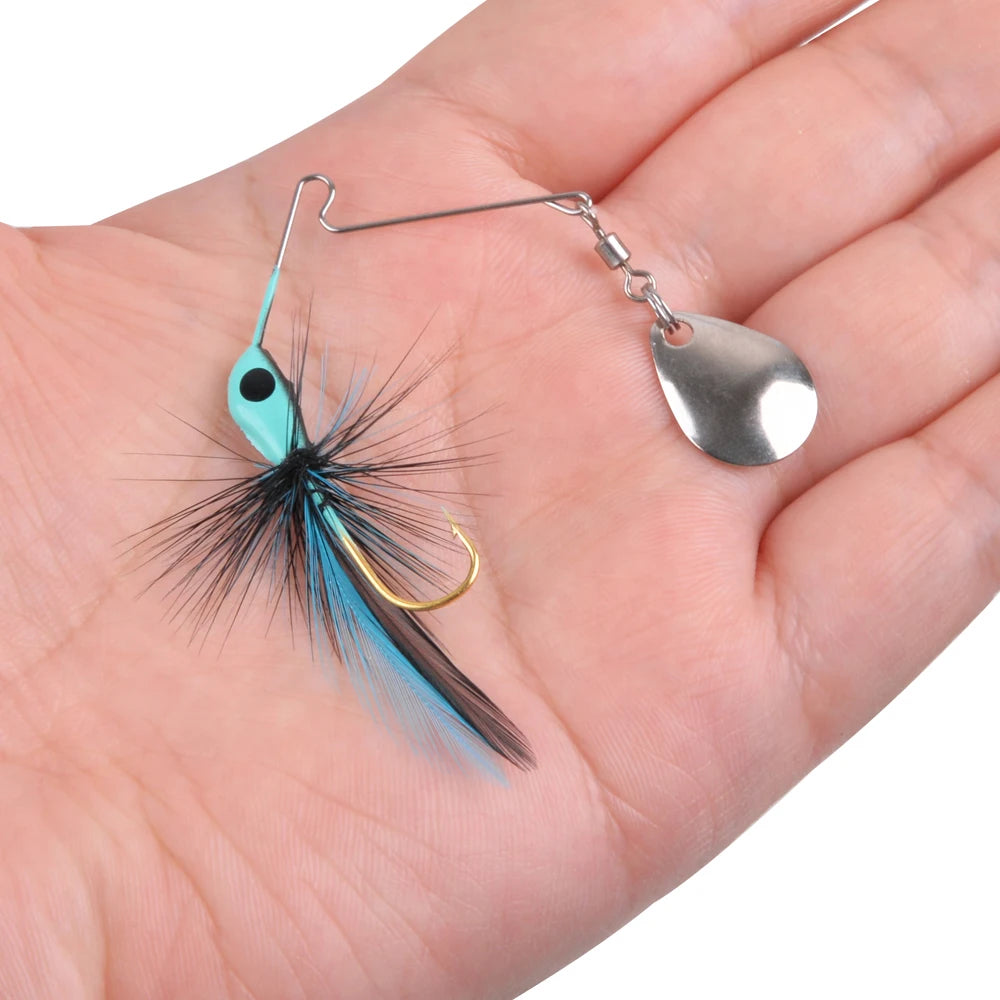 Blue and black feather fishing lure with metal spinner and gold hook held in hand