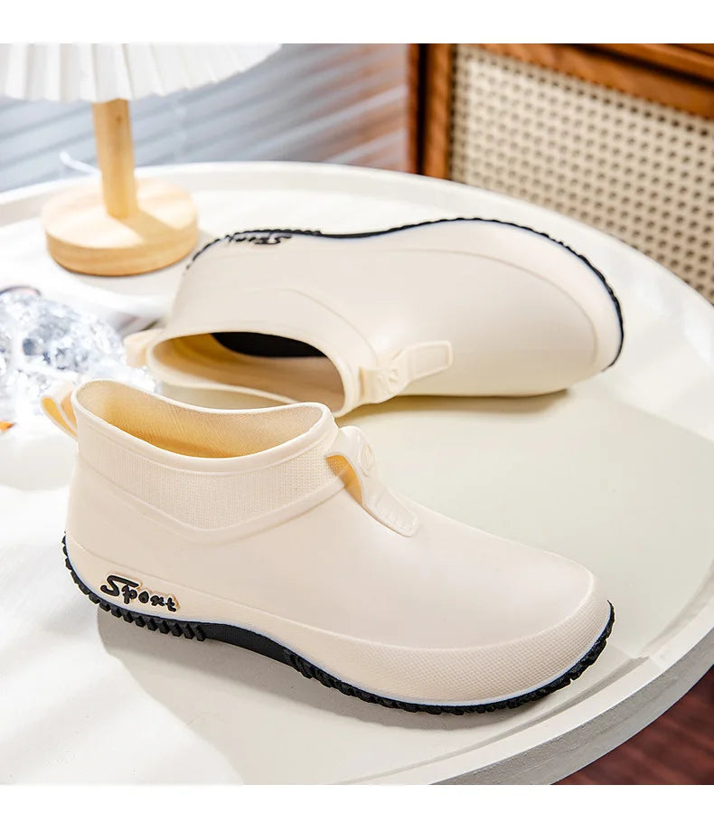 White sneakers with black soles on a white surface