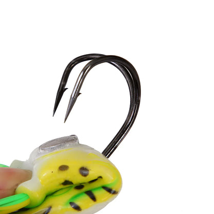 Close-up of a double hook yellow and green fishing lure with black spots