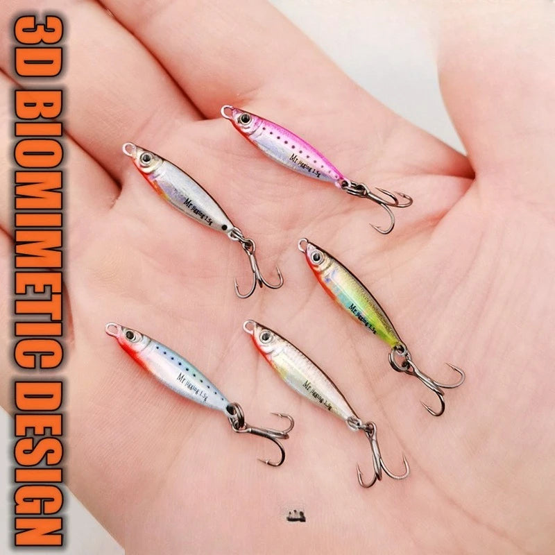 Hand holding five colorful 3D biomimetic fishing lures with treble hooks for outdoor fishing.