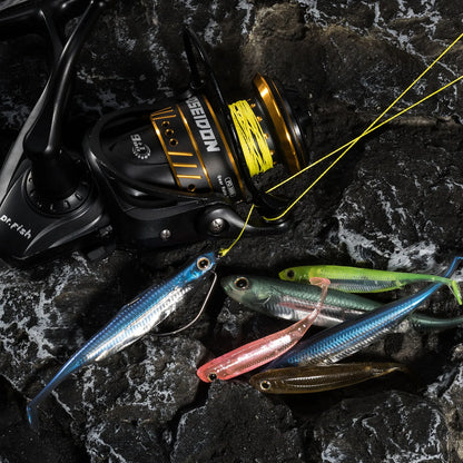 Fishing reel with neon line and assorted soft bait lures on textured black rock