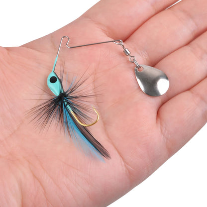 Hand holding a blue and black feather fishing lure with spinner blade for outdoor fishing