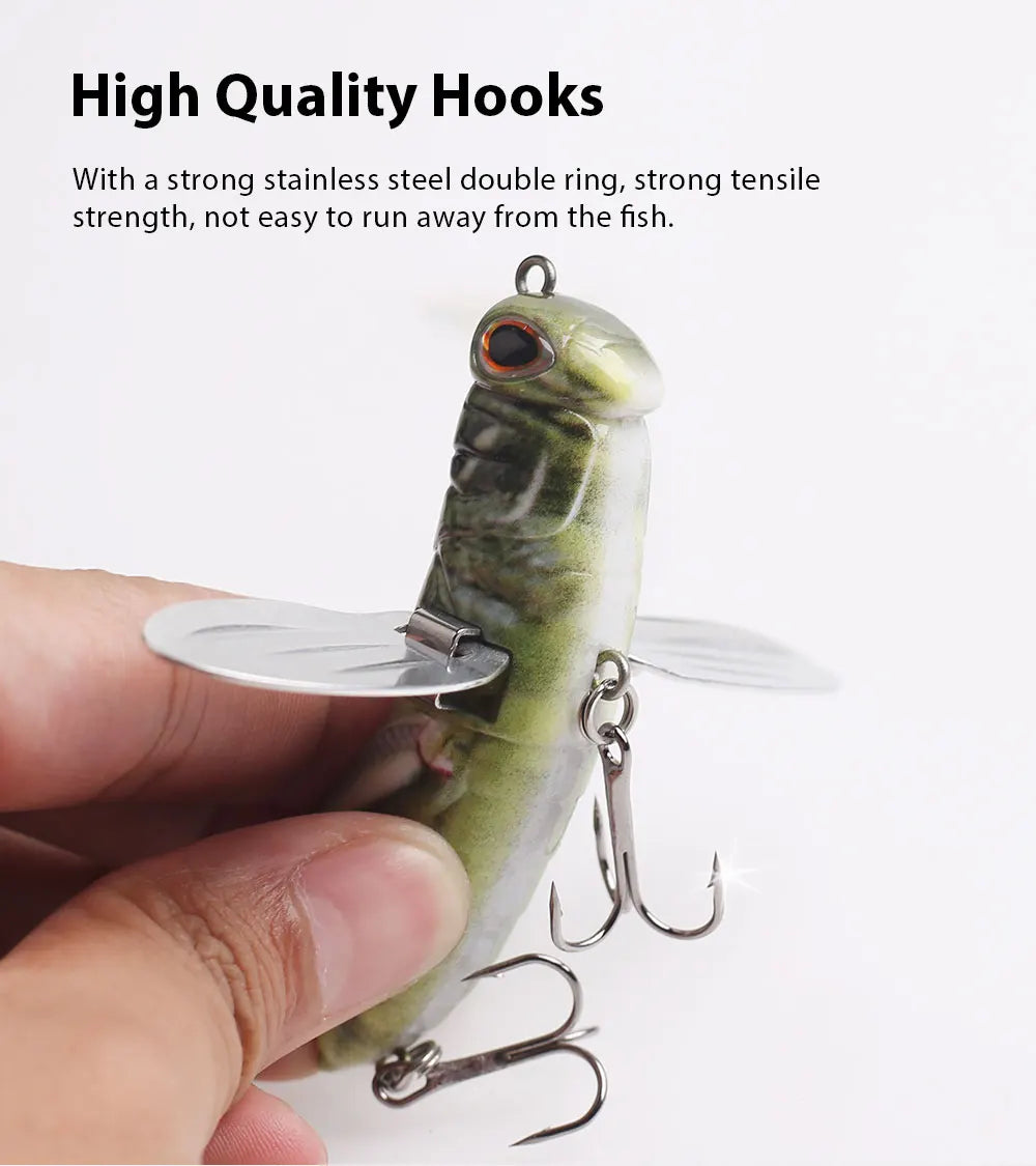 Hand holding durable fish-shaped fishing lure with stainless steel treble hooks and metal wings