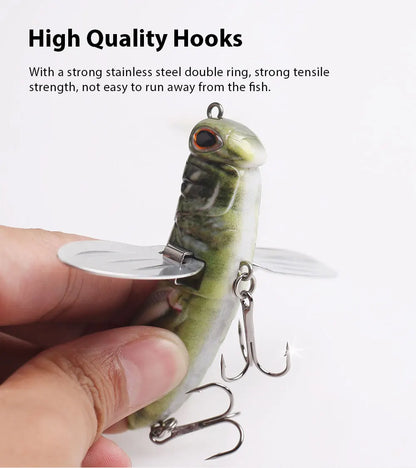 Hand holding durable fish-shaped fishing lure with stainless steel treble hooks and metal wings