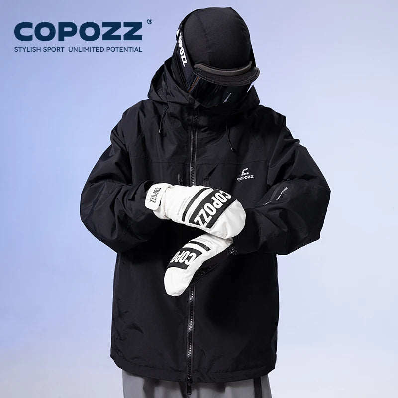 Person wearing a black COPOZZ jacket and gloves on a light blue background