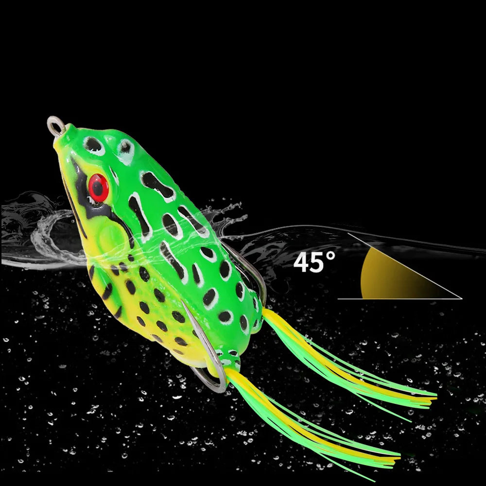 Realistic green frog fishing lure with red eye, floating in water at 45 degree angle.