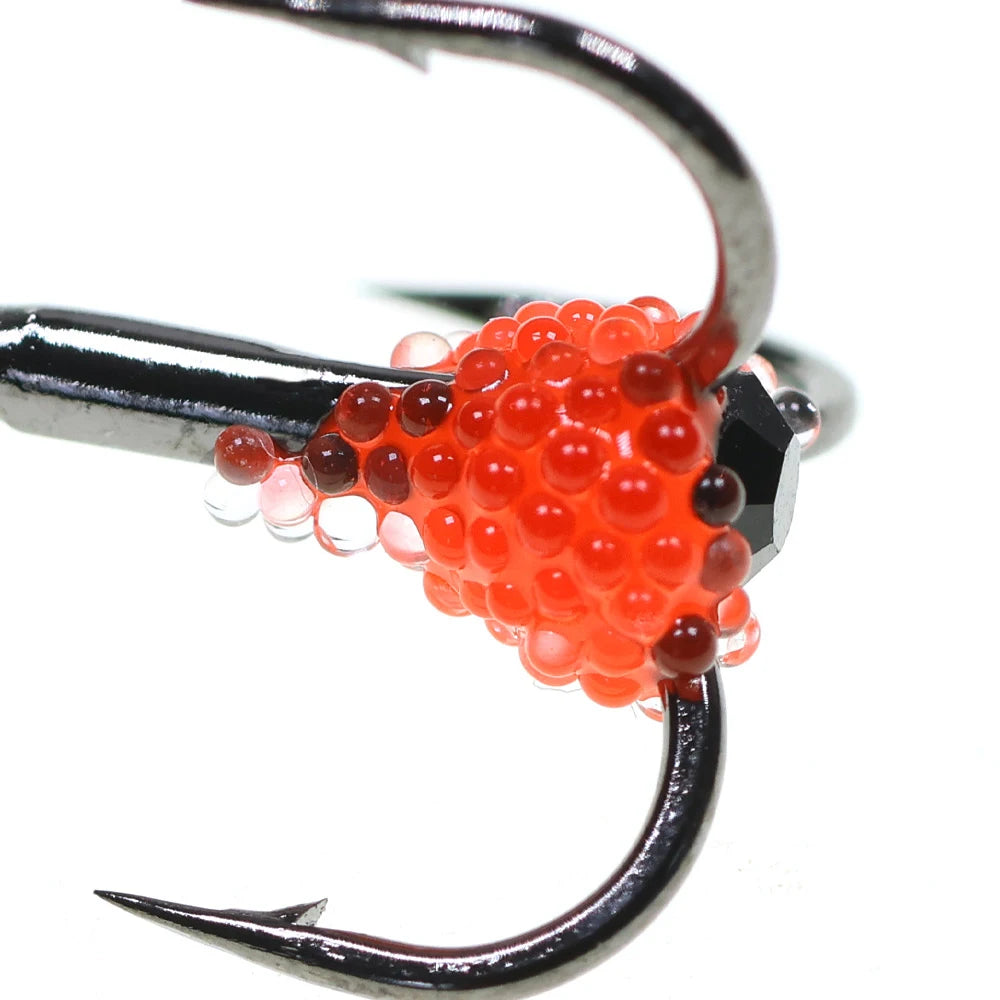 Close-up of a fishing treble hook with red bead bait for outdoor fishing gear