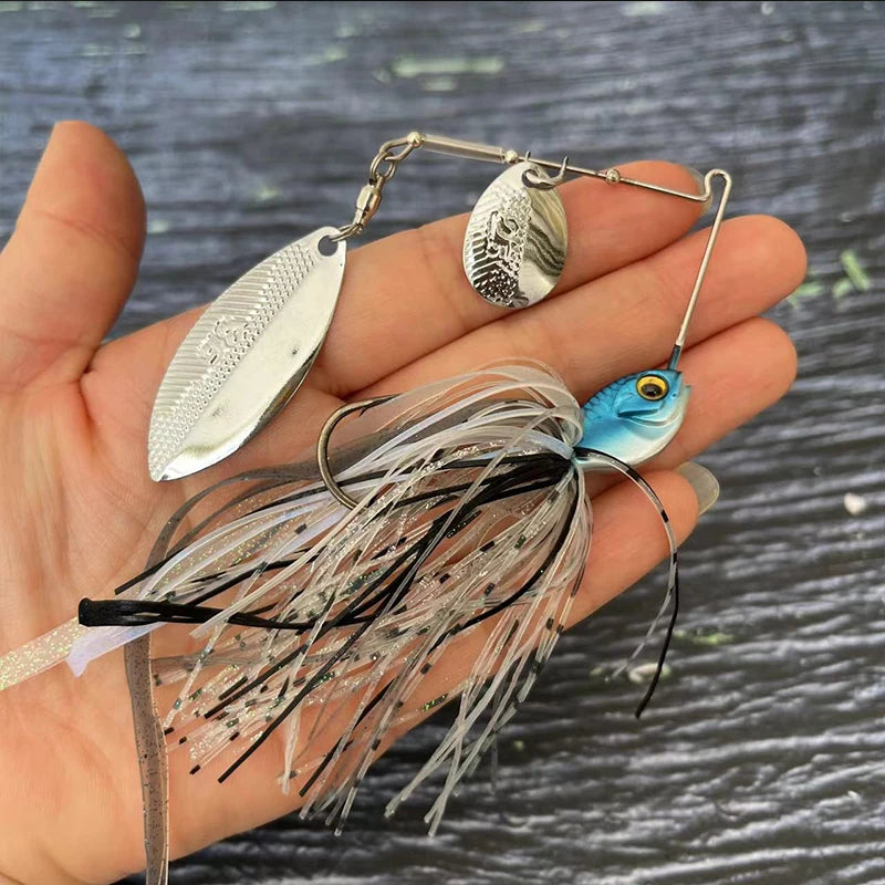Hand holding a fishing spinnerbait lure with metallic blades and lifelike fish head