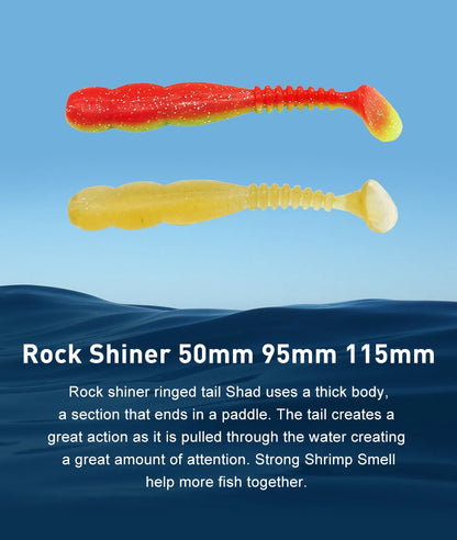 Two soft plastic paddle tail fishing lures, one red-yellow and one yellow, on blue background.